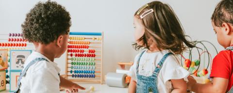 three children playing in a child care center